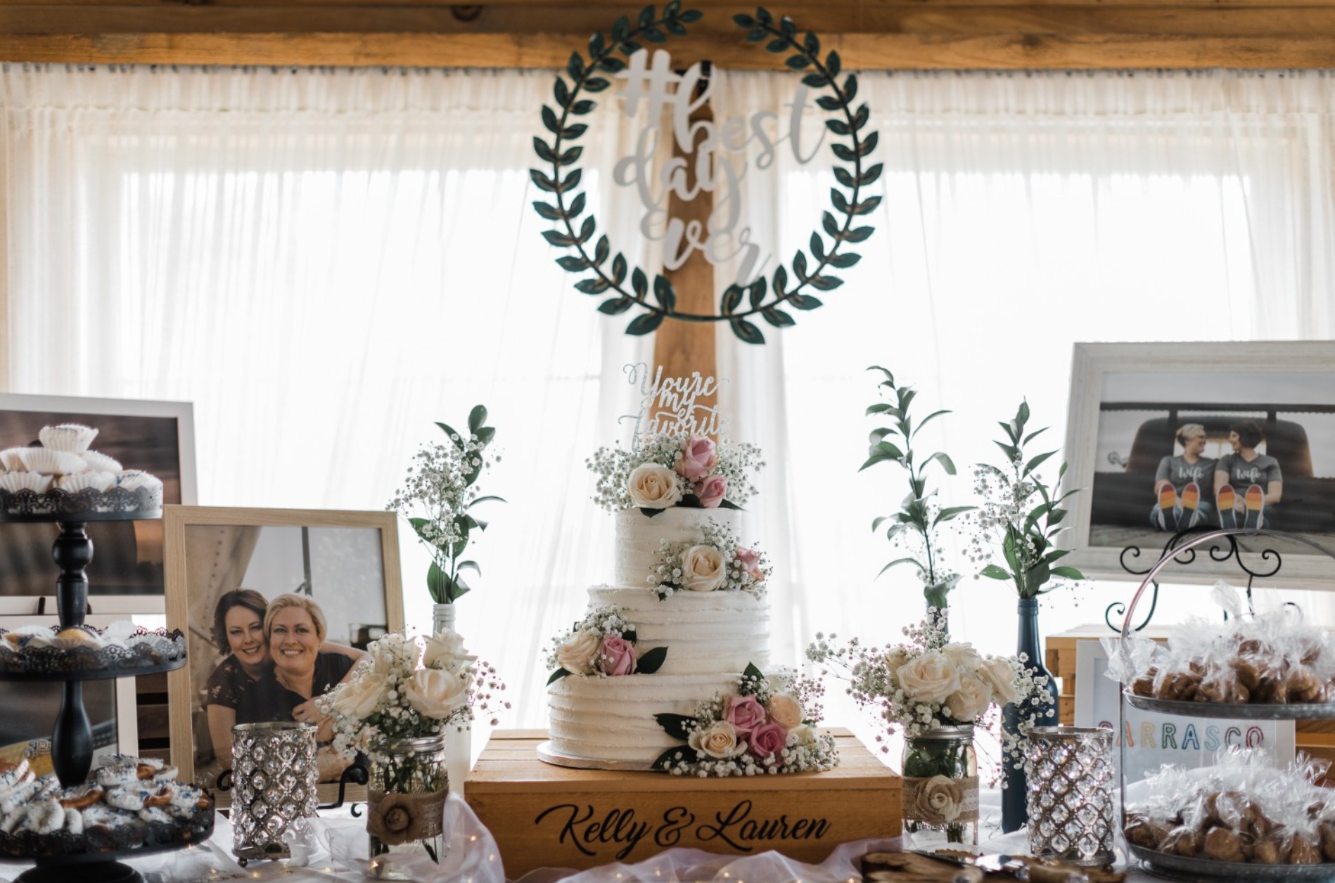 Wedding cake and dessert display with framed photos