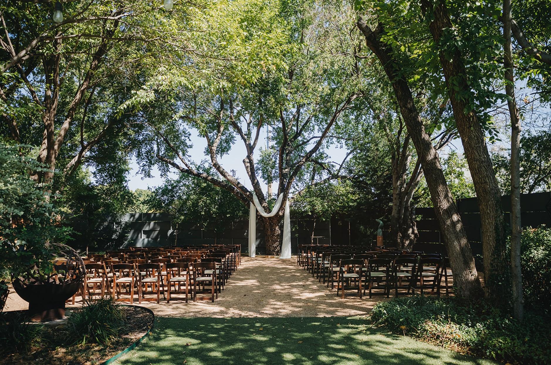 Outdoor wedding ceremony aisle under trees