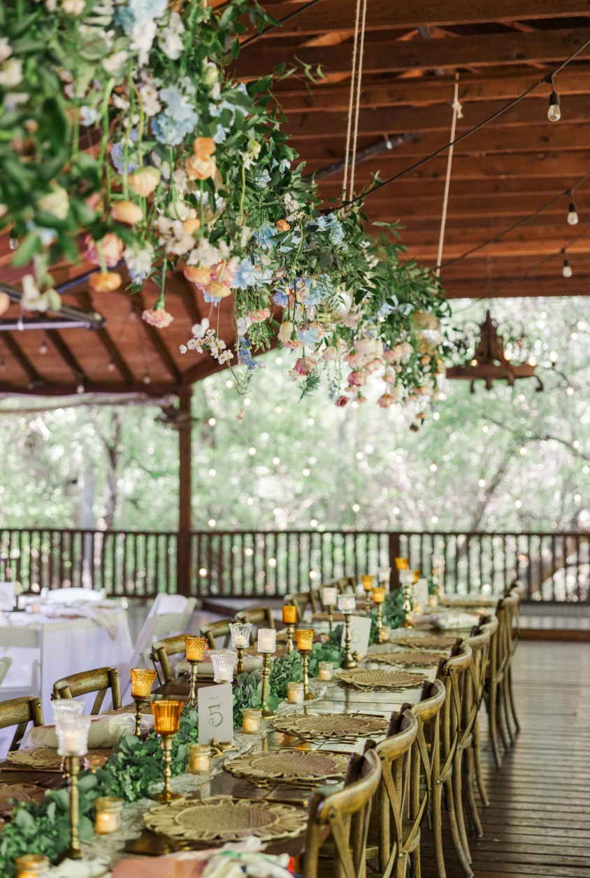 Reception tables with greenery and warm lights