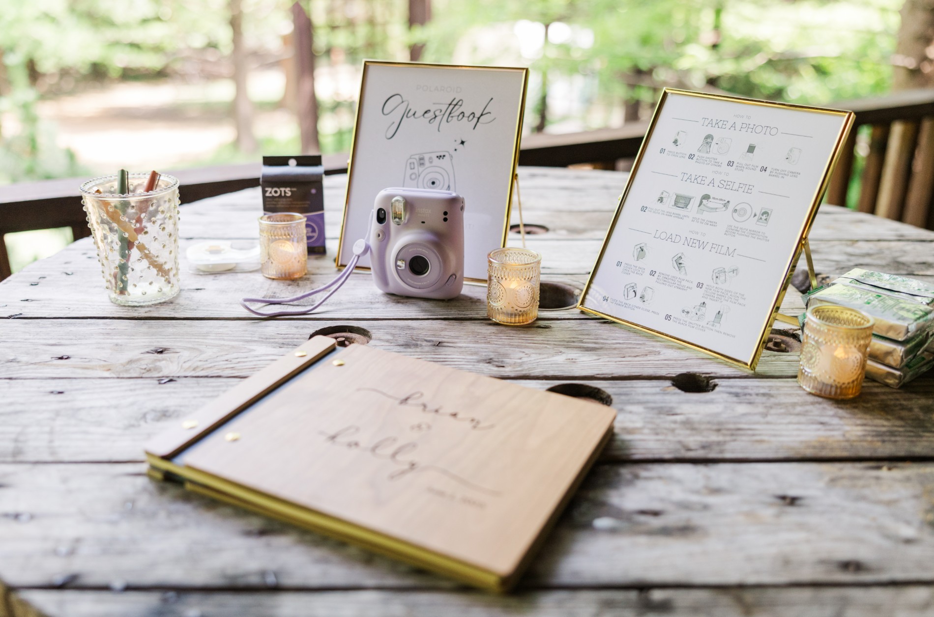 Wedding guestbook table with camera and signs