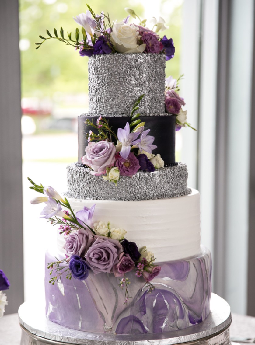 Purple and white wedding cake with floral details