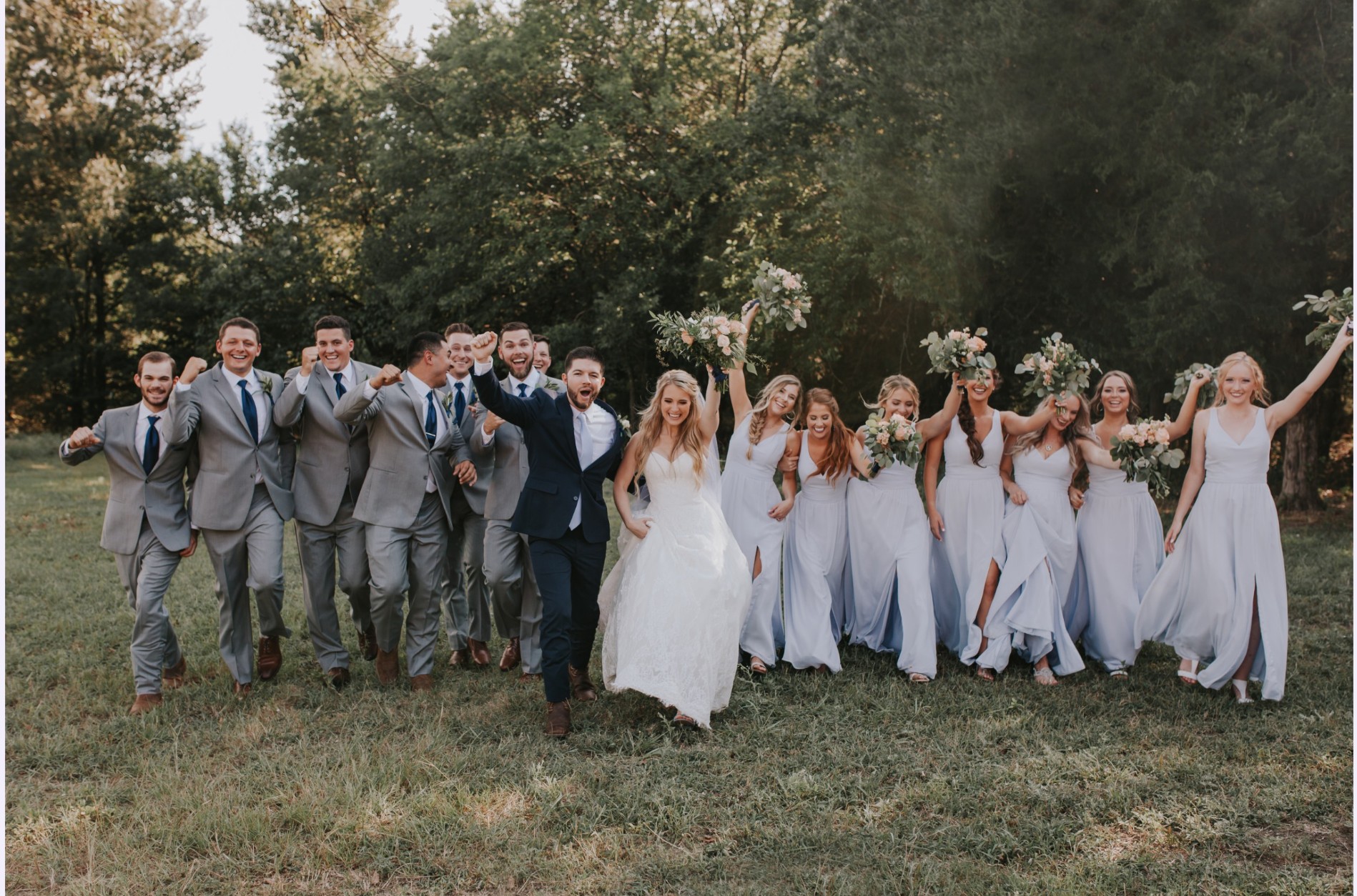 Bride and groom walking with their wedding party