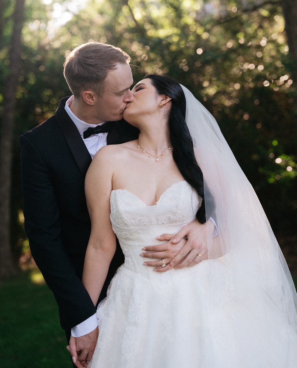Newlyweds sharing a kiss outdoors