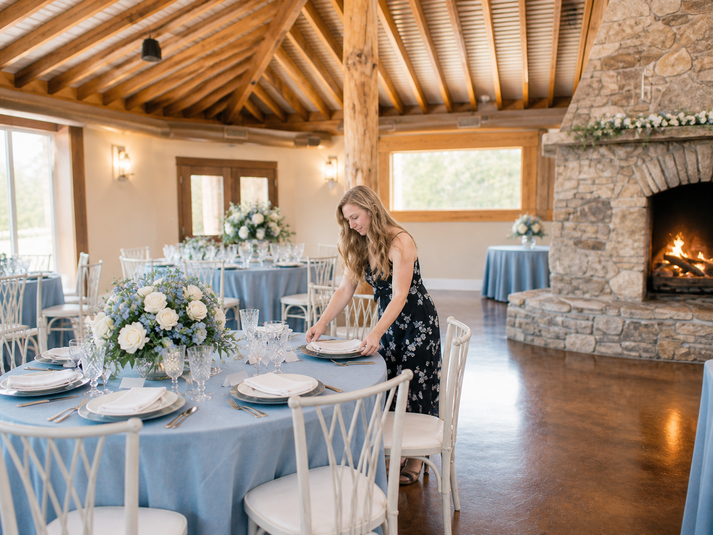 Jessie Craig setting a blue and white wedding reception table
